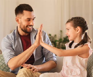 child & parent give a hi-five